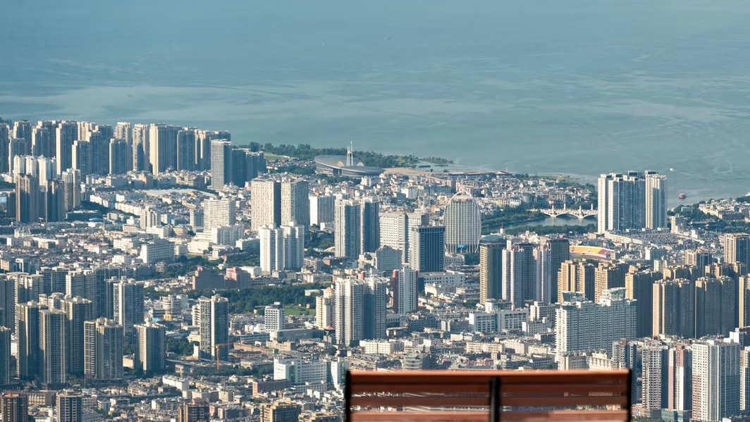 Wooden bench on a viewing deck high above Dali city, with Erhai Lake beyond