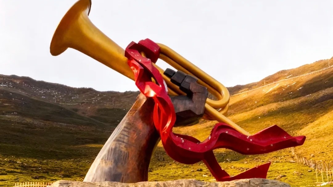 The Red Army crossing monument on Jiajin Mountain Pass, a bronze bugle sculpture above an inscribed stone base.