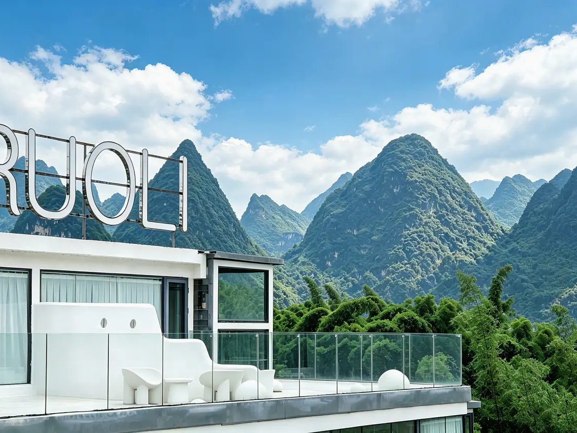 White rooftop terrace under a RUOLI sign, green karst peaks across the valley
