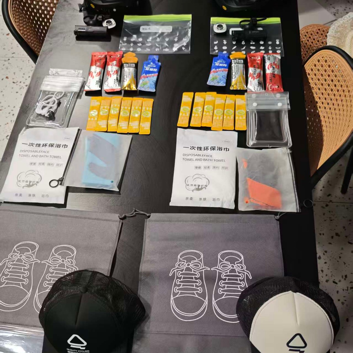 Helmets, energy gels and bars, towels and caps laid out on a table before the ride