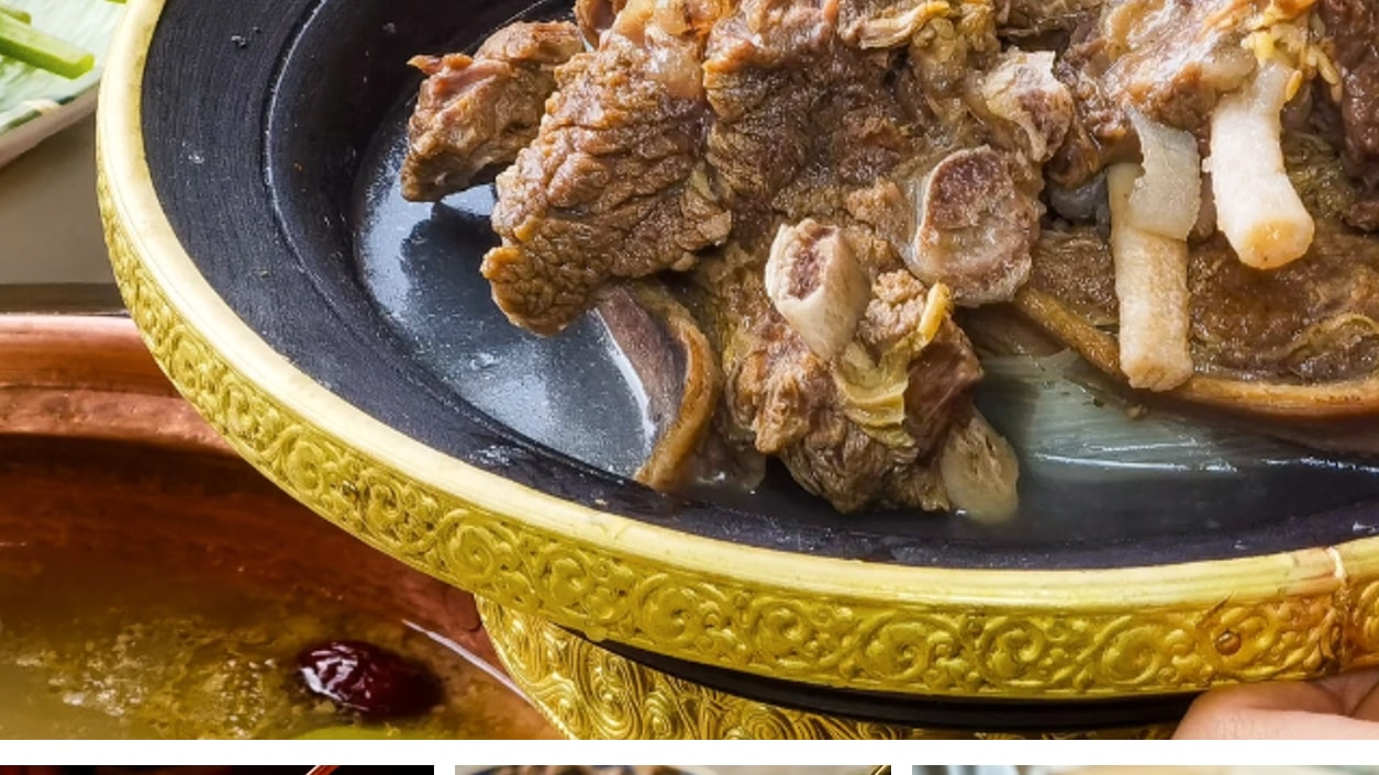 Traditional boiled yak meat served in a gold bowl with regional side dishes and desserts.