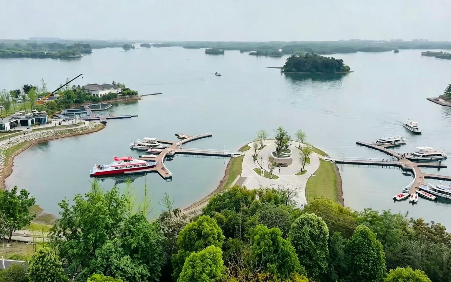 Aerial view of Sancha Lake near Chengdu, with wooded islands, boat piers and the lakeside roads used by the cycling loop
