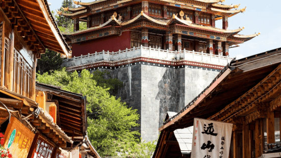 A multi-tiered Tibetan temple overlooking a traditional street in the Shangri-La Old Town, Yunnan.