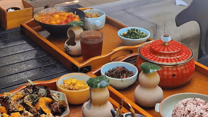 Imperial-style Beijing dishes with multi-grain rice and side dishes served at Na Jia Xiao Guan restaurant.