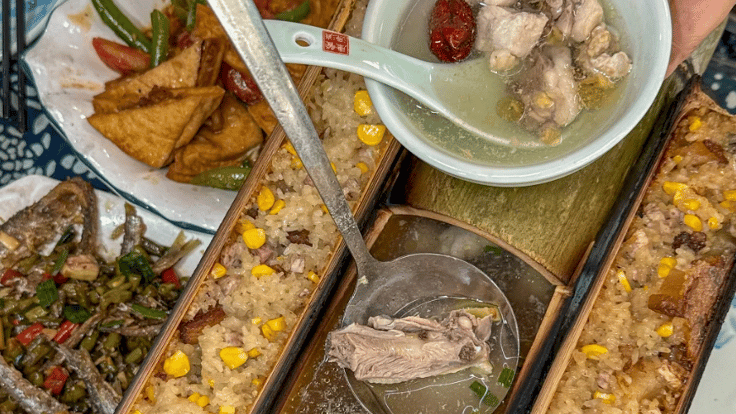 Traditional bamboo rice and chicken soup served in bamboo tubes with assorted Chinese side dishes.